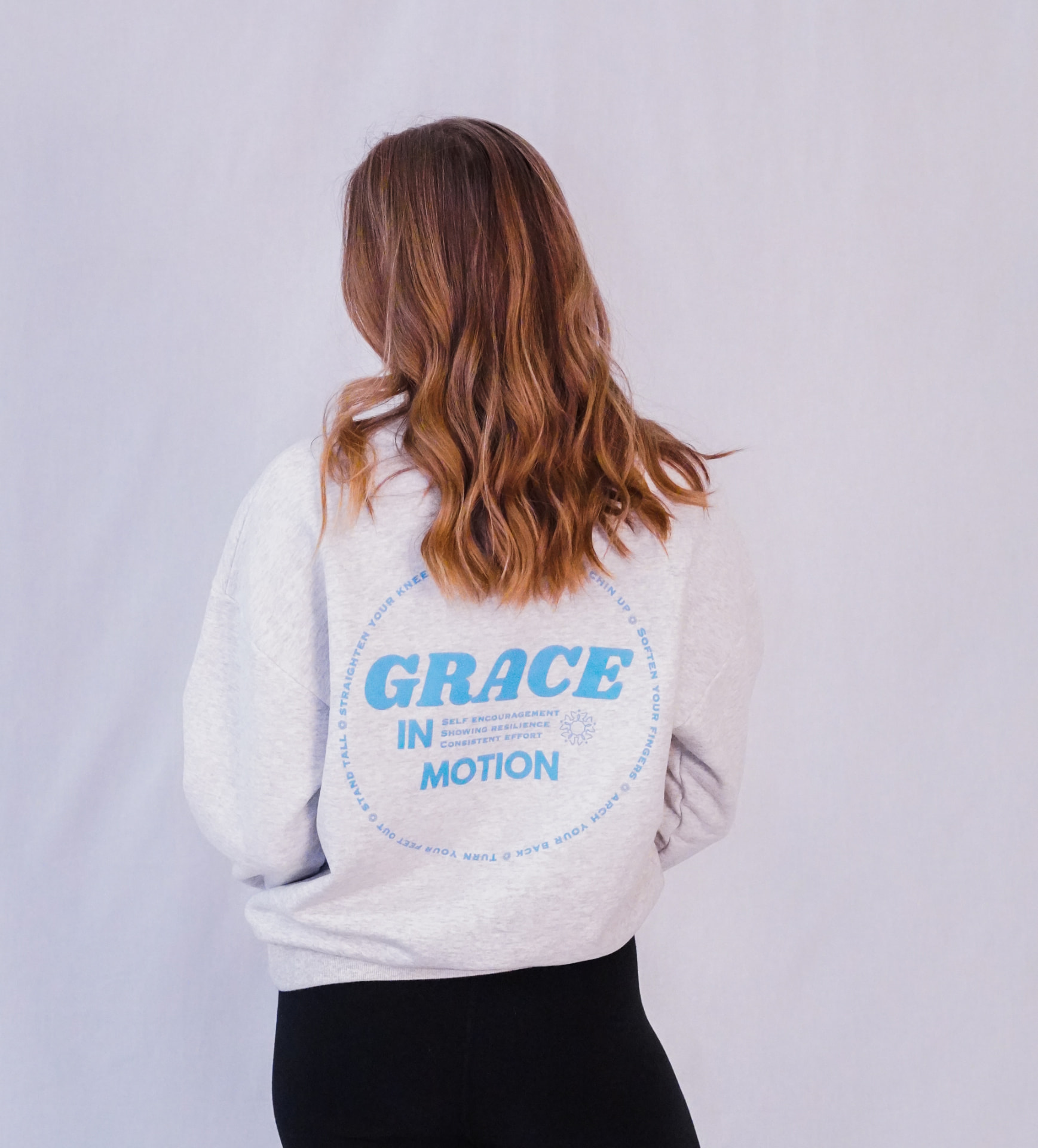 Model wearing the mist Grace in Motion crewneck from the back