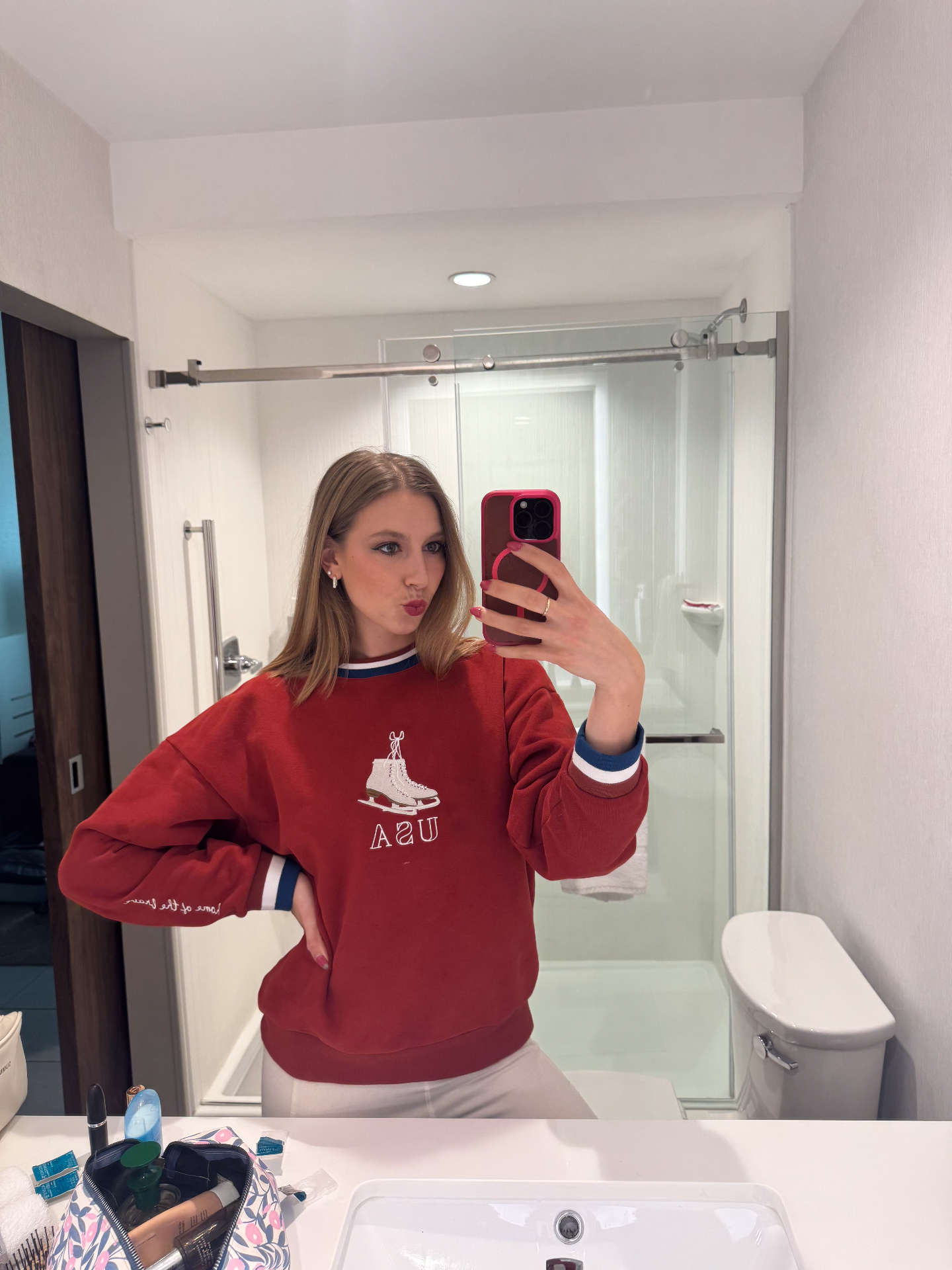 Customer wearing the red USA crewneck in a mirror selfie showing the sleeve detail