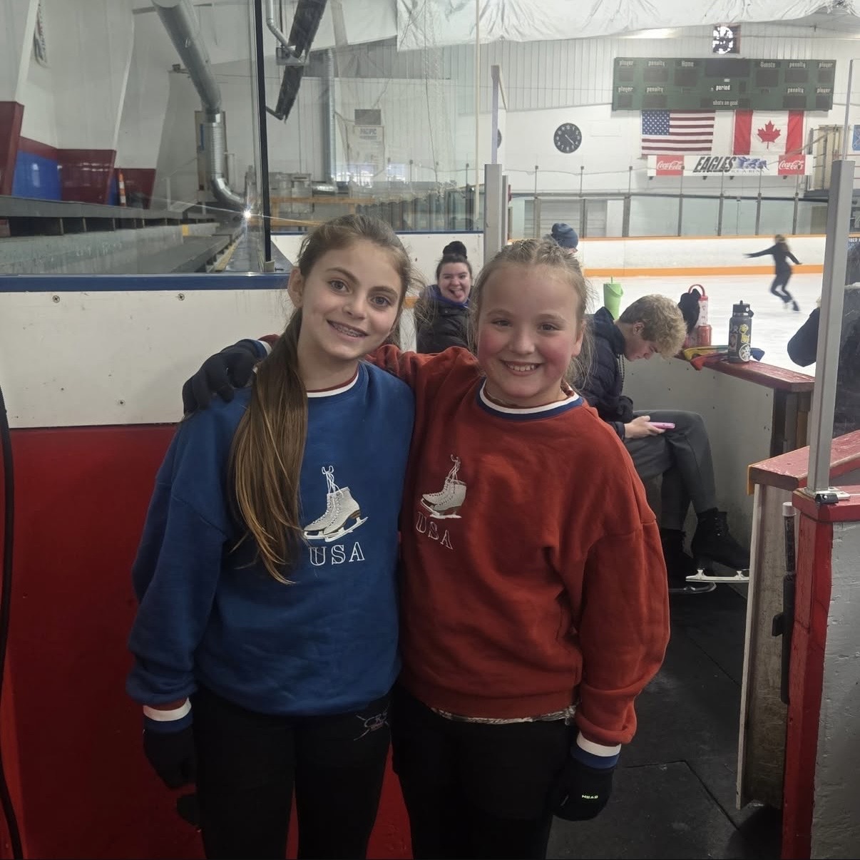 Young skaters at the rink wearing the Blue USA crewneck