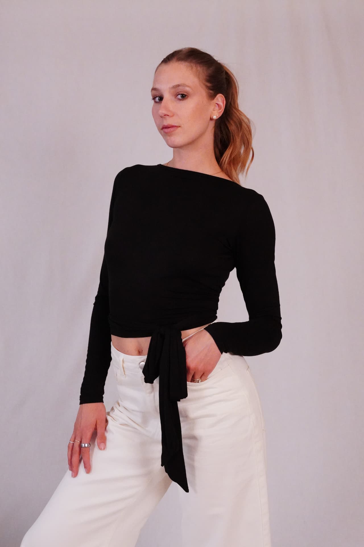 Model wearing the Ballet Wrap Top in Black Swan, front view