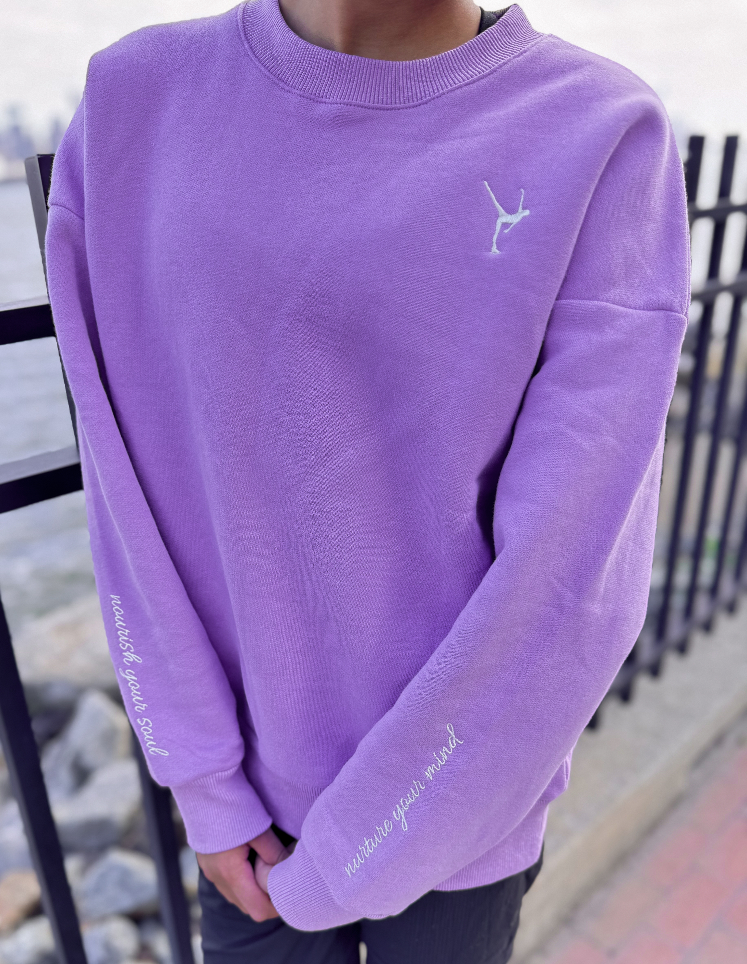 Close-up of the orchid Grace in Motion crewneck front embroidery and sleeve details