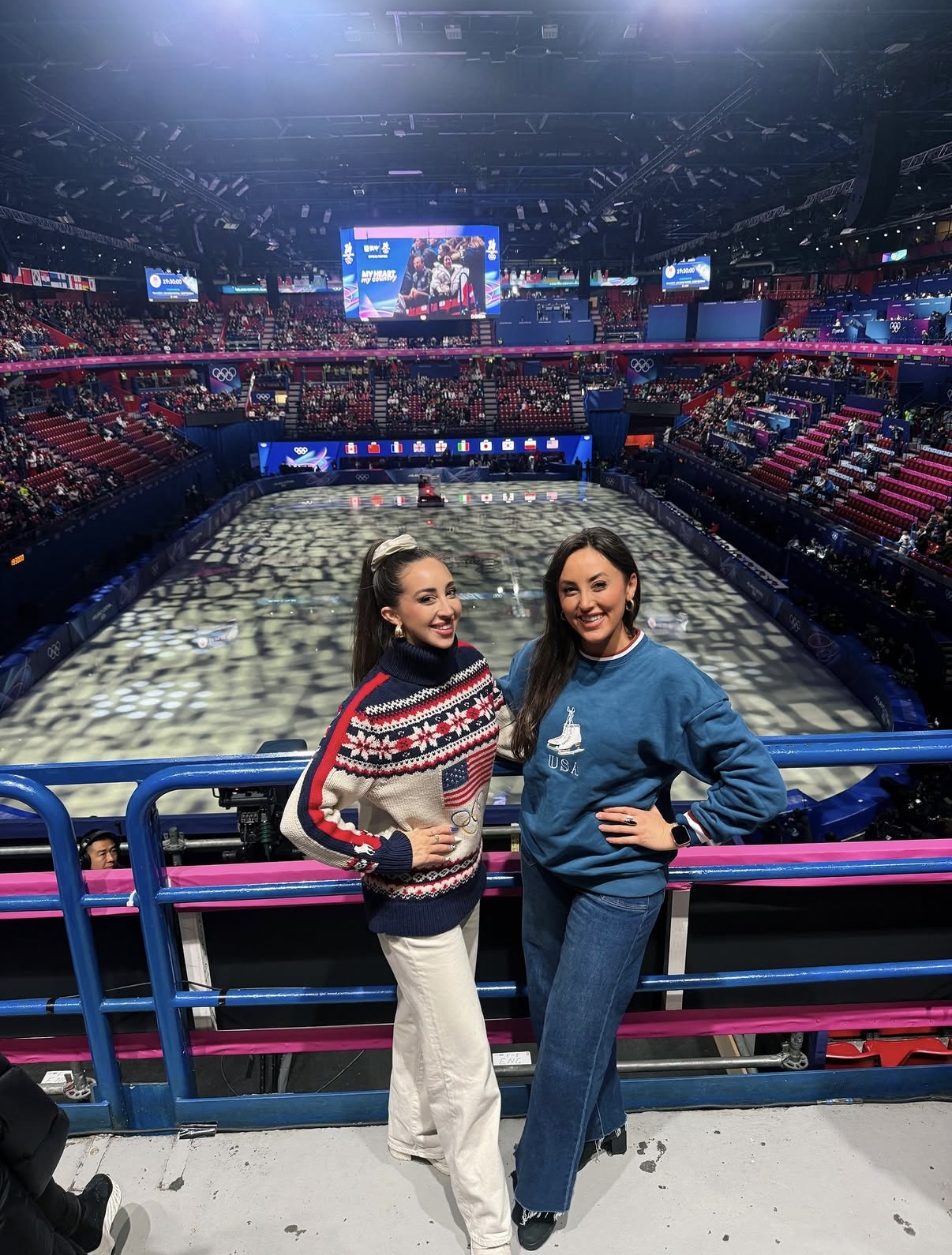 Skater wearing the Blue USA crewneck at the Olympic figure skating arena